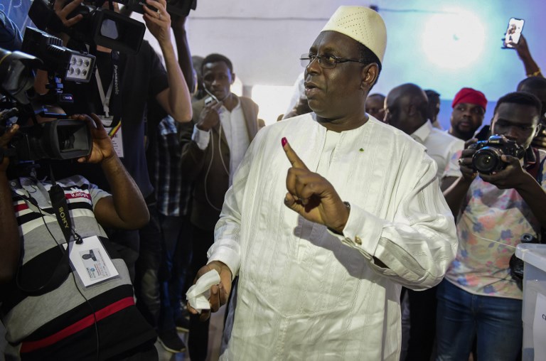 TAKES FIRST ROUND. Incumbent President Macky Sall shows his finger marked with indelible ink after casting his vote for Senegal's presidential elections in a ballot box at a polling station in Fatick on February 24, 2019. Photo by Seyllou/AFP  