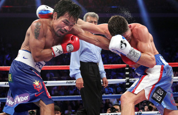 EXCHANGE. Pacquiao dodges Algieri's right as he throws a left to the New Yorker's body. Photo by Chris Farina/Top Rank