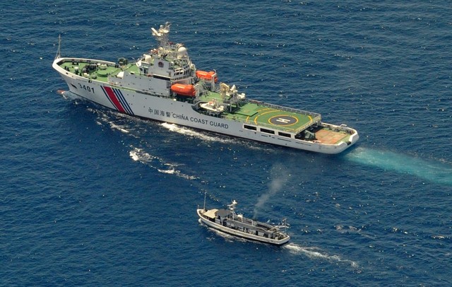 CODE OF CONDUCT. A China Coast Guard ship (top) and a Philippine supply boat engage in a stand off as the Philippine boat attempts to reach the Second Thomas Shoal, a remote South China Sea a reef claimed by both countries, on March 29, 2014. File photo by Jay Directo/AFP 