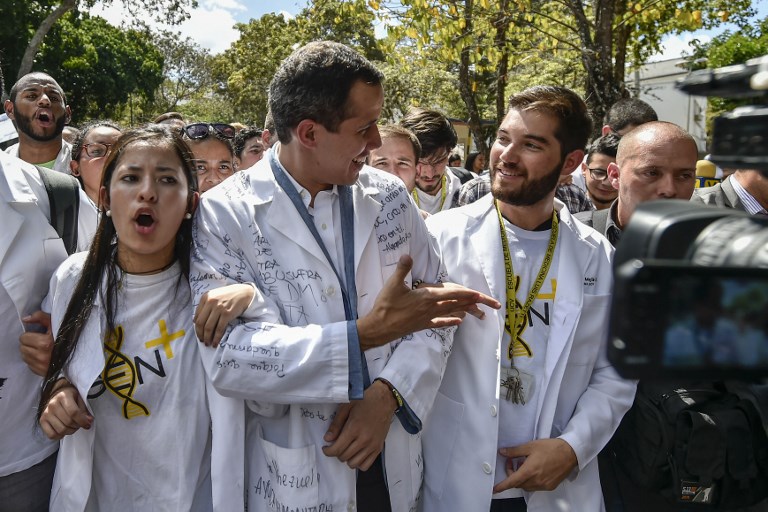 PROTESTS. Opposition leader and self-proclaimed 'acting president' Juan Guaido (center), marches surrounded by students during a protest he convened against the government of President Nicolas Maduro, outside Venezuela's Central University (UCV) in Caracas.
Photo by Luis Robayo/AFP   
