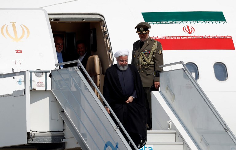 ROUHANI IN SWITZERLAND. Iranian President Hassan Rouhani (C) disembarks from an aircraft after his arrival at an airport in Kloten - Zurich Canton - on July 2, 2018, at the start of a two day official visit to Switzerland. 
Photo by Ruben Sprich/AFP 