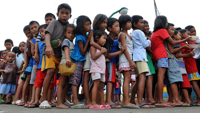 Filipino children line up in a feeding program. File photo by Jay Directo/AFP