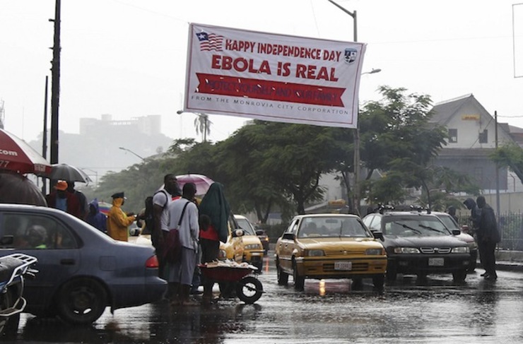 IN YOUR FACE. Photo made available 27 July 2014 of an Ebola poster being placed above a street in downtown Monrovia as Liberia marked its 167th Independence anniversary on 26 July 2014. Ahmed Jallanzo/EPA
