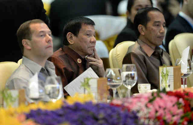 DUTERTE'S FOREIGN POLICY. President Rodrigo Duterte sits beside Russian Prime Minister Dmitry Medvedev (L) and Indonesia's President Joko Widodo at the gala dinner during the second day of the Association of Southeast Asian Nations (ASEAN) Summit in Vientiane on September 7, 2016. Photo by Noel Celis/AFP 