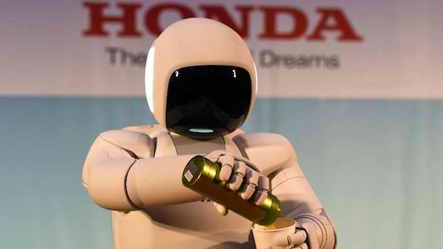 ASIMO. Honda's humanoid robot pours liquid into a cup. File photo from AFP 