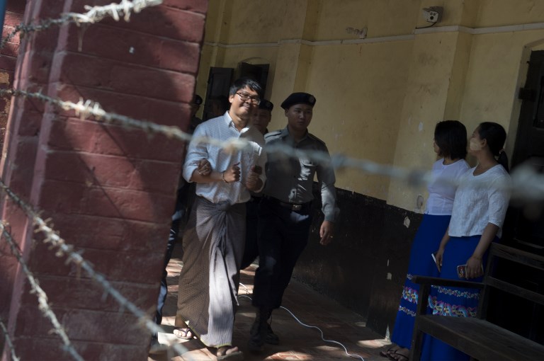 WA LONE. Detained Myanmar journalist Wa Lone (L) is escorted by police to a court in Yangon to face trial on February 6, 2018. Photo by Romeo Gacad/AFP 