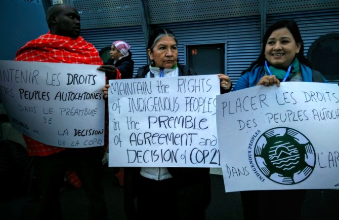 ARTICLE 2 ISSUE. Indigenous peoples at COP21 hold placards inside the conference venue, demanding that their rights should remain under the preamble and article 2 of the climate agreement. Photo by Tebtebba   