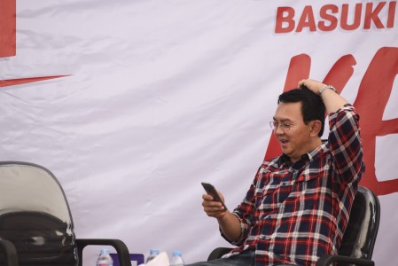 Calon Gubernur DKI Jakarta Basuki Tjahaja Purnama memainkan telepon selularnya saat menerima pengaduan warga di Rumah Lembang, Jakarta, Rabu (16/11). Foto oleh Hafidz Mubarak/ANTARA 