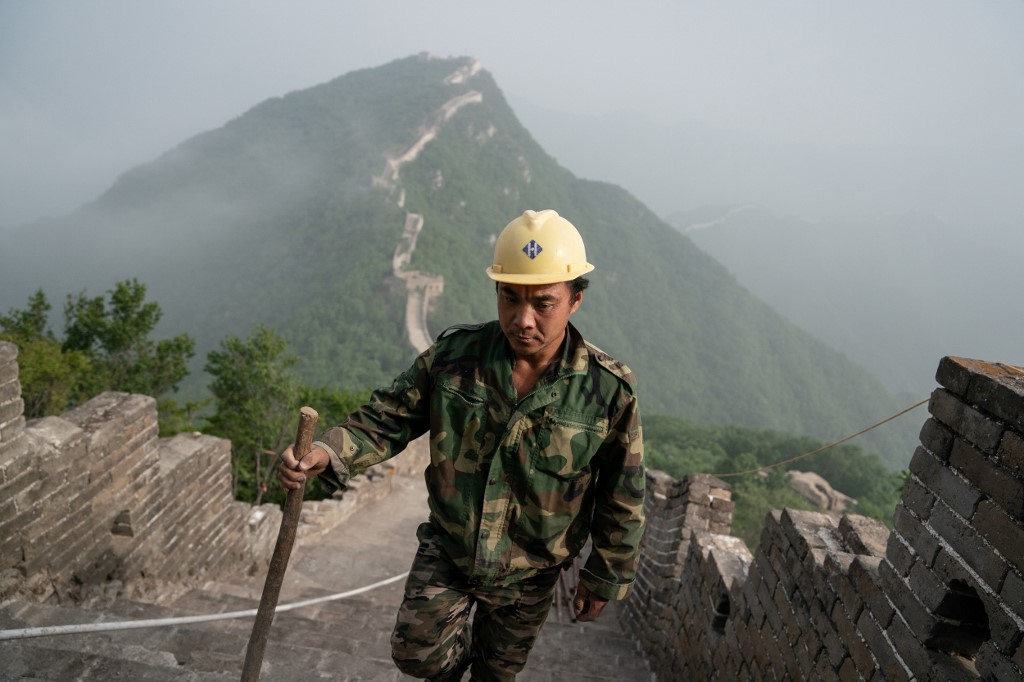 MANUAL. This picture taken on May 17, 2019 shows a worker inspecting a restored part of the Great Wall in Xiangshuihu in Huairou District, on the outskirts of Beijing. Photo by Fred Dufour/AFP  