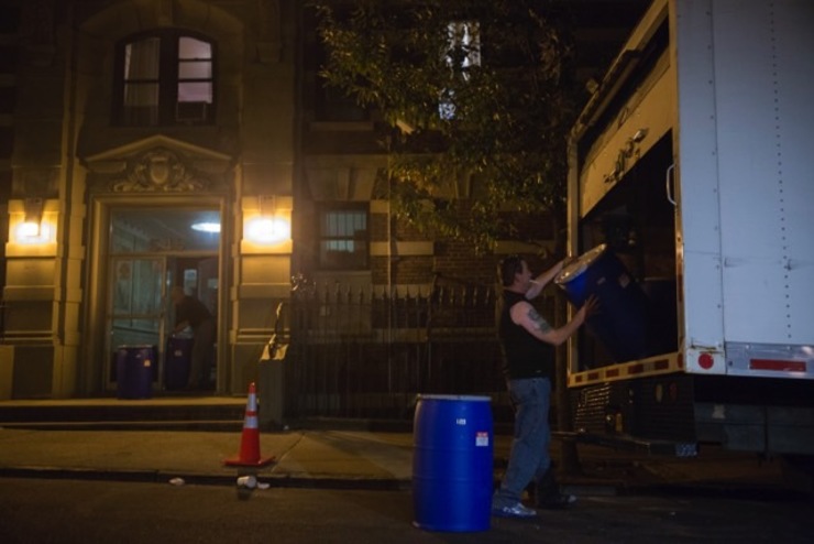 PREPARED. Workers are seen carrying plastic barrels from the apartment building where Ebola patient Craig Spencer lived in Harlem, New York, USA, 24 October 2014. Photo by John Taggart/EPA