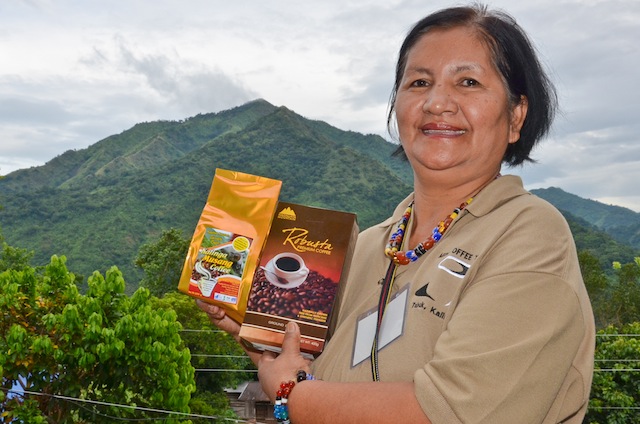 LOCALLY PACKED. Zita Degay proudly presents her Magallaya Mountain Specialty Coffee products which she named after the mountain peak (background) in her village. 