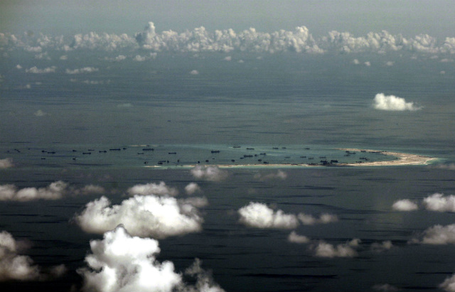 RECLAMATION ACTIVITIES. An aerial photo taken though a glass window of a military plane shows the ongoing reclamation by China on Mischief Reef, part of the disputed Spratly Islands in the South China Sea, west of Palawan, Philippines, on May 11, 2015. Photo by Ritchie Tongo/EPA/Pool