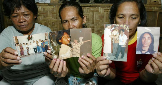 VICTIMS OF VIGILANTEISM. Family members of boys allegedly slain by vigilante groups in Davao City hold of photos of their dead. Photo from Human Rights Watch 