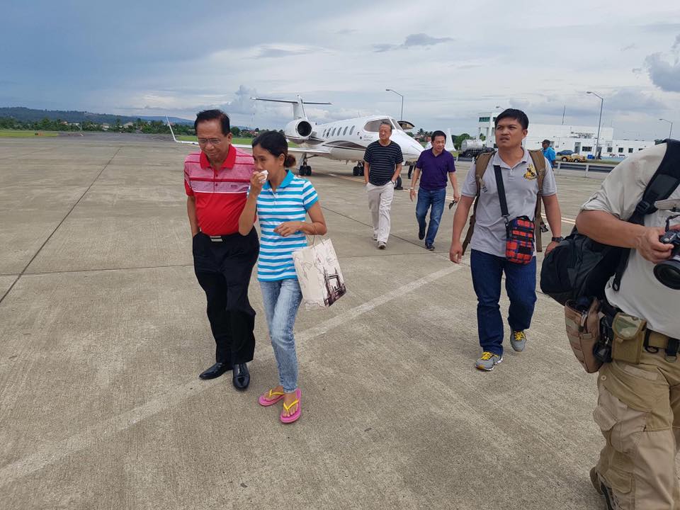 SAFETY. Incoming peace process adviser Jesus Dureza brings hostage Marites Flor to Davao. Photo from Dureza's Facebook page.  