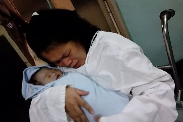 LAST EMBRACE. Andrea Rosal, daughter of the late NPA spokesperson, weeps as she holds her dead baby named after her. Photo by Free Andrea Rosal Movement 