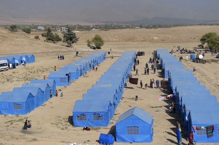AFGHANISTAN. In this photograph taken on October 19, 2016, Afghans who were displaced by Kunduz fighting between Afghan forces and Taliban insurgents, walk at a makeshift camp in the outskirts of Kabul. File photo by Shah Marai/AFP 