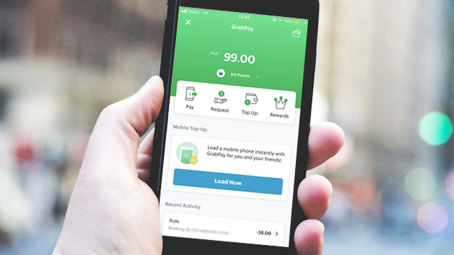 INTEGRATION. Grab Philippines President Brian Cu says their digital payment GrabPay will also be integrated in other services. Image from Shutterstock, Grab app screengrab 