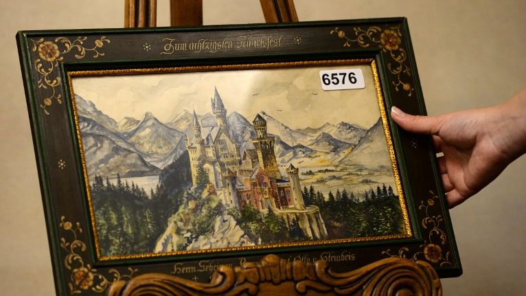HITLER ART. The Weidler auction house presents a watercolor panting of Neuschwanstein Castle that is signed A. Hitler. Photo by Christof Stache/AFP 