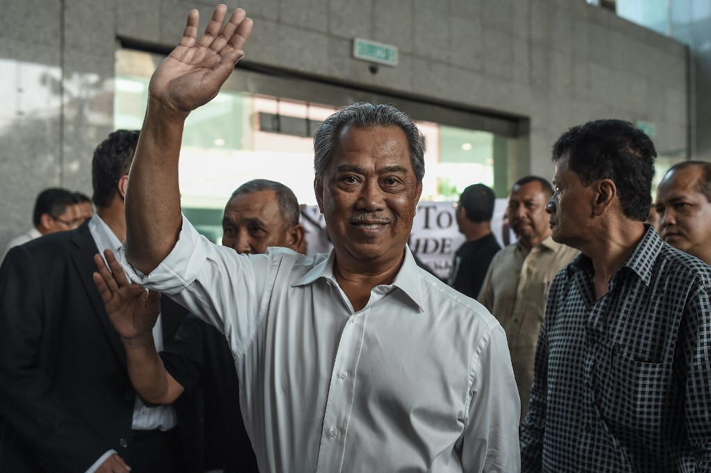 SUPRISE VICTORY. Malaysia's former deputy prime minister Muhyiddin Yassin (C) waves as he arrives to submit an application for a new political party in Putrajaya, outside Kuala Lumpur on August 9, 2016. Photo by Mohd Rasfan/AFP 