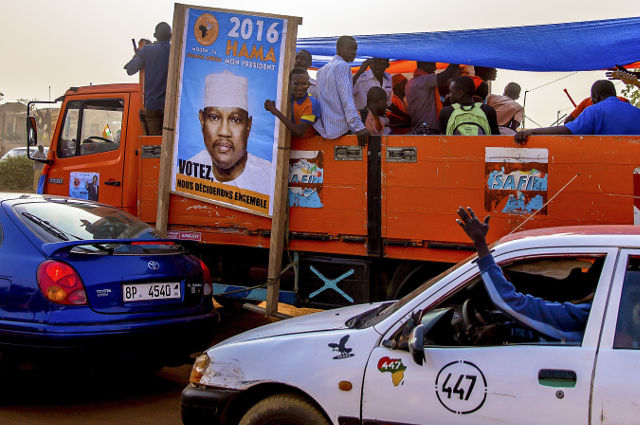 HAMA AMADOU. Supporters in a bus carry a campaign poster for presidential candidate Hama Amadou which reads in French 'Vote, we will decide together' in Niamey, Niger February 13, 2016. File Photo by Arne Gillis/EPA 