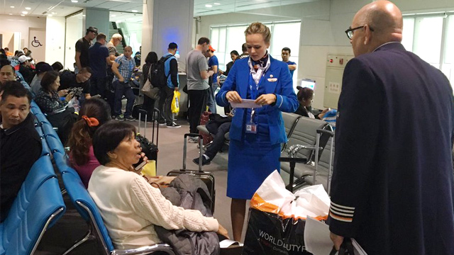 APPEASEMENT. Royal KLM staff address passenger concerns for the cancelled flight due to the closure of the Ninoy Aquino International Airport. Photo courtesy of Manja Bayang 