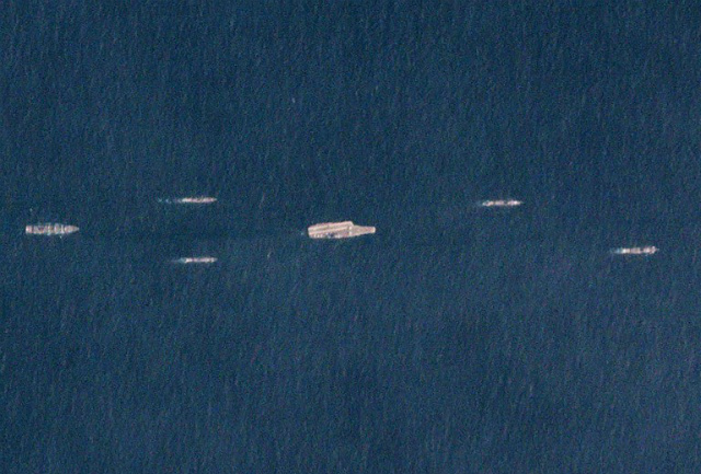 CHINA MUSCLE. This handout satellite picture taken on March 26, 2018 released by Planet Labs Inc. shows China's sole operational aircraft carrier, the Liaoning (C), sailing with other ships at sea, south of China's southern Hainan island. Photo by Planet Labs Inc/AFP  