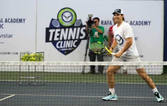 Rafael Nadal smiles as he plays tennis with young Filipinos. Photo by Ena Terol/Rappler 