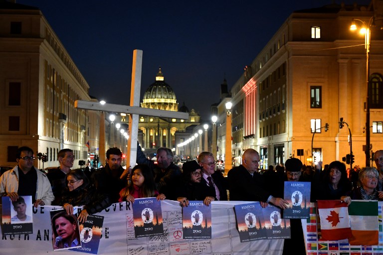 END ABUSE. Members of Ending Clergy Abuse (ECA), a global organization of prominent survivors and activists, hold a protest gathering on February 21, 2019 by the Castel Sant'Angelo in Rome, with the Vatican's St. Peter's basilica in background. Photo by Alberto Pizzoli/AFP 