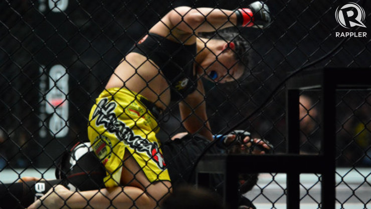Ana Julaton throws hammer fists at Aya Saber moments before the fight is stopped. Photo by Nevin Reyes/Rappler