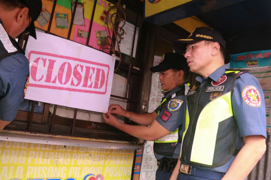 SHUT DOWN. Members of the Philippine National Police, including NCR top cop Guillermo Eleazar (right most), immediately close PCSO establishments following President Duterte's order. NCRPO photo