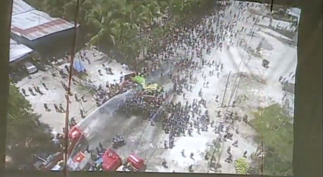 VIOLENT DISPERSAL. Video shown by the PNP supposedly shows a small group of police (middle of photo) being surrounded by protesters. Screenshot 