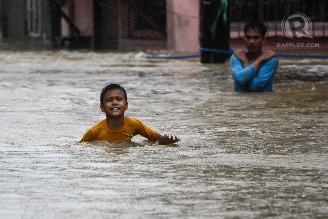 BRAVING DISASTER. During Tropical Storm Mario (Fung-Wong) in September 2014, a young boy wades through a flooded street in Marikina City in the Philippines. File photo by Manman Dejeto/Rappler  