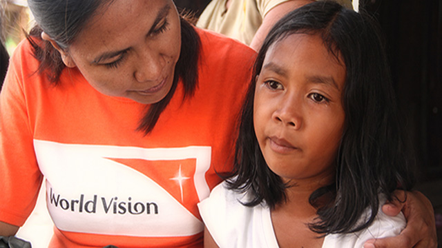 BREAKING DOWN. A 10-year-old girl suddenly breaks into tears as her mother narrates how they huddled together near a mango tree when Typhoon Yolanda struck. Photo by World Vision