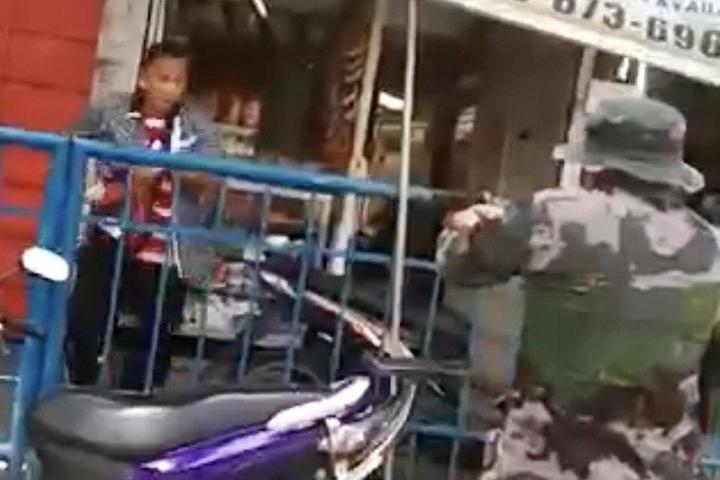 CONFRONTATION. The Quezon City cop shoots a quarantine violator after the latter allegedly tried to pull out a gun from his sling bag. Screenshot from sourced video. 