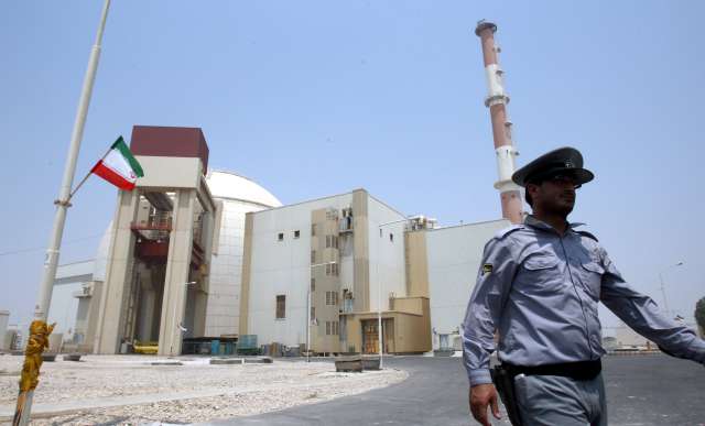 Seorang penjaga di depan fasilitas pembangkit listrik tenaga nuklir di Iran. Foto oleh: Abedin Taherkenareh/EPA 