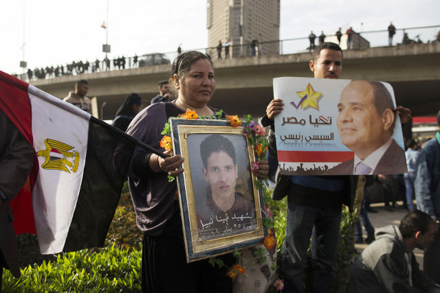ANTI-TERROR LAW. A supporter of Egyptian President Abdel Fattah al-Sisi, stands beside the relative of a martyr during events commemorating of the anniversary day of the 2011 uprising, in Cairo, Egypt, 25 January 2015. Photo by Almasry Alyoum /Osama Said/ EPA 