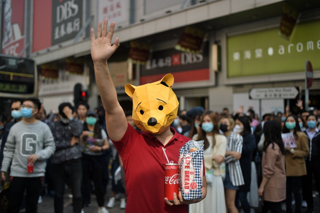LIFE BREAD. A man wears a 'Winnie the Pooh' mask and hold a loaf of Life Bread as he joins others in a lunchtime flash mob rally in the Cheung Sha Wan district in Hong Kong on November 29, 2019. Photo by Philip Fong/AFP 