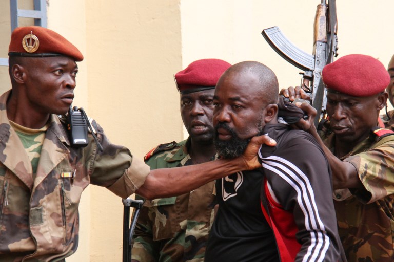 EX-MILITIA. In this file photo taken on October 29, 2018 members of the armed forces arrest Central African MP Alfred Yekatom aka "Rambo" (C), who represents the southern M'baiki district former militia leader, after he fired the gun at the parliament in Bangui. Photo by Gael Grilhot/AFP 