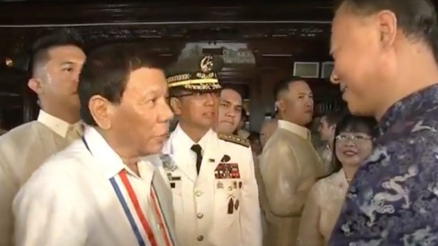 FRIENDLY TIES. President Rodrigo Duterte chats with Chinese Ambassador to the Philippines Zhao Jianhua during the Independence Day ceremony in Kawit, Cavite on June 12, 2018. RTVM screenshot 