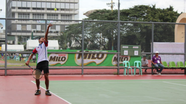 SERVING FOR GLORY. Noel Damian Jr. of the Philippine Tennis team looks to smash his way out of a big hole in his encounter against the agile Jirat Navasirisomboon of Thailand. Photo by Ferdin Sanchez/ Rappler