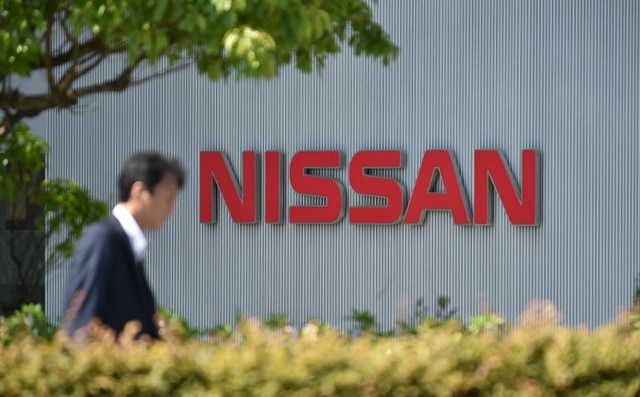 NISSAN. This file photo shows a man walking in front of the logo of Japan's Nissan Motor Corporation at its global headquarters in Yokohama, Kanagawa prefecture. File photo by Kazuhiro Nogi/AFP 