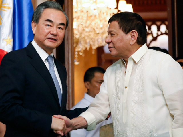 CLOSER TIES. Philippine President Rodrigo Duterte shakes hands with Chinese Foreign Minister Wang Yi, who was paying a courtesy call in Malacañang on July 25, 2017. Malacañang file photo  