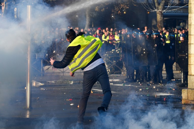 PROTEST. A demonstrator throws a projectile on November 17, 2018 in Quimper, western France, during a nationwide popular initiated day of protest called "yellow vest" (Gilets Jaunes in French) movement to protest against high fuel prices. Photo by Fred Tanneau/AFP 