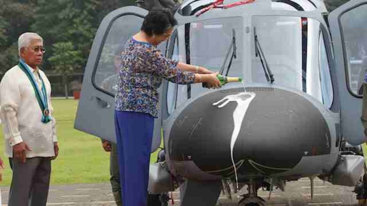 BRAND NEW CHOPPERS: File photo of the wife of Defense Secretary Voltaire Gazmin performing the ceremonial pouring of the champagne. Photo from Armed Forces of the Philippines