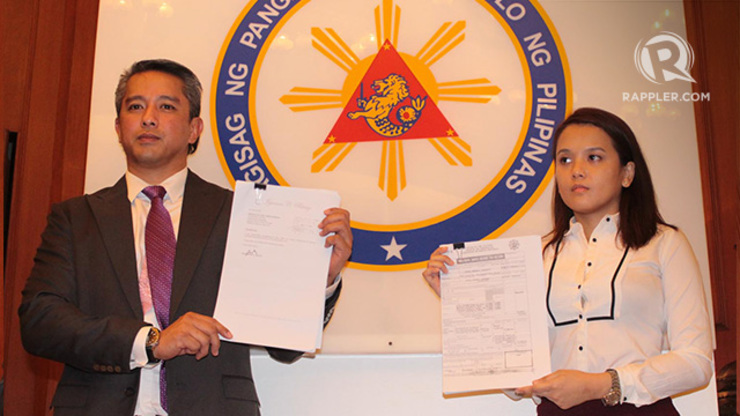 NOTHING TO HIDE. Vice President Jejomar Binay’s spokesman Cavite Governor Jonvic Remulla (L) and counsel Princess Turgano (R) hold copies of the vice president’s SALNs and ITRs. Photo by Joel Leporada/Rappler
