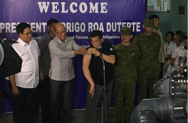 DUTERTE'S TATTOO. President Rodrigo Duterte shows his tattoo as the public demands to see if his son Paolo has a 'triad' tattoo. Photo by Carmela Fonbuena/Rappler 