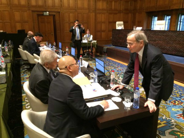HISTORIC HEARINGS. The Philippines' lead counsel against China, Paul Reichler (right), confers with Philippine Foreign Secretary Albert del Rosario (1st from left) and Philippine Solicitor General Florin Hilbay (2nd from left) on the 1st day of hearings on the merits of the Philippines' case. Photo by Abigail Valte 