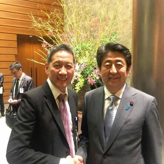 JAPAN TRIP. Businessman Samuel Uy shakes hands with Japanese Prime Minister Shinzo Abe on the sidelines of President Duterte's official visit to Japan last October. Photo from Uy's Facebook page 