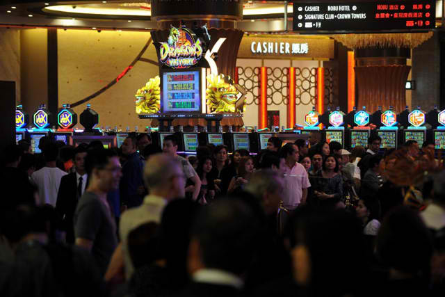 CASINOS UNDER AMLA. Tourist and casino players arrive at the grand opening of the City of Dreams mega-casino in Manila on February 2, 2015. File photo by Jay Directo/AFP 