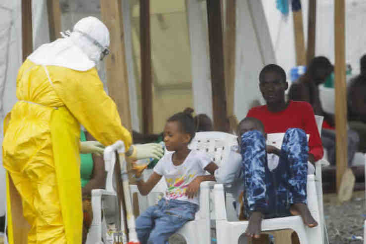 MEDICATION. A photograph made available 13 October 2014 shows a Liberian health worker gives medication to a young Ebola patient at the MSF Treatment Unit in Monrovia, Liberia 20 September 2014. Ahmed Jallanzo/EPA